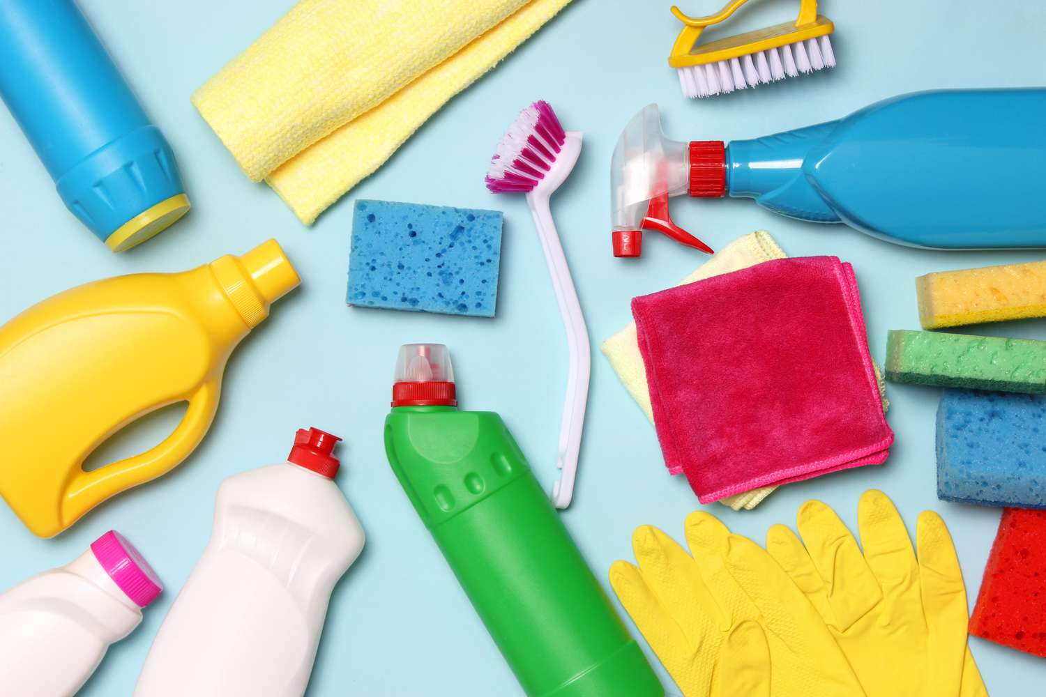 Hands scrubbing a dishwasher filter with a toothbrush