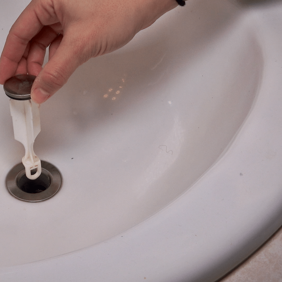 Bathroom sink with a strainer in use to prevent clogs
