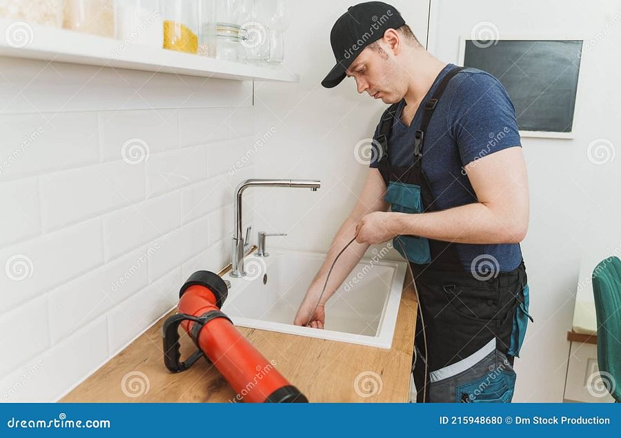 drain snake unclogging kitchen sink