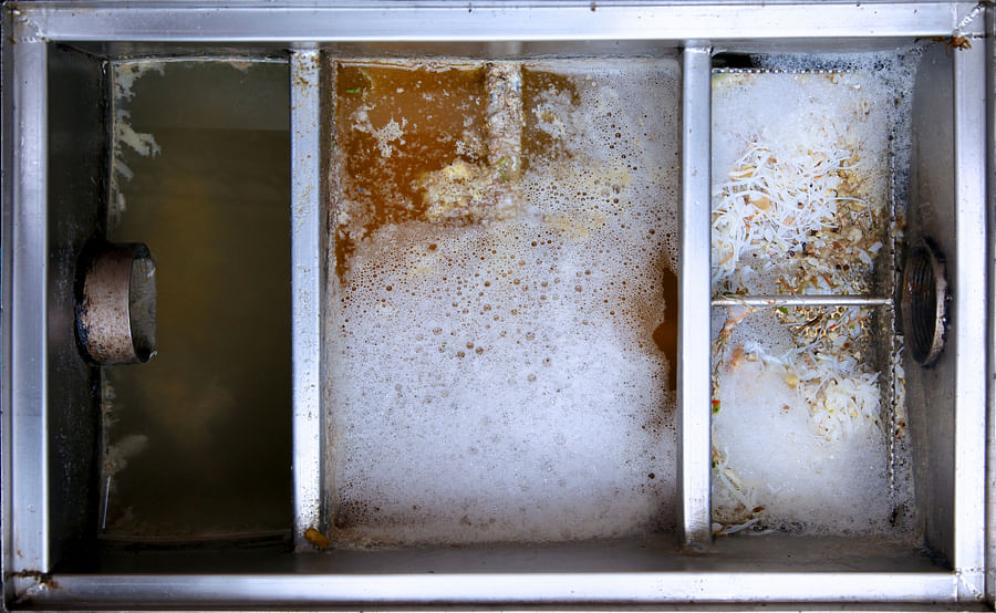 Clean and well-maintained grease trap in a commercial kitchen
